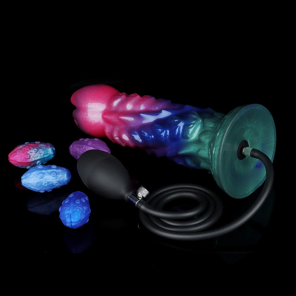 The bottom view of the large 9.9cm suction cup base of the alien fantasy dildo with the black inflation bulb pump hose connected to the metal inlet valve.