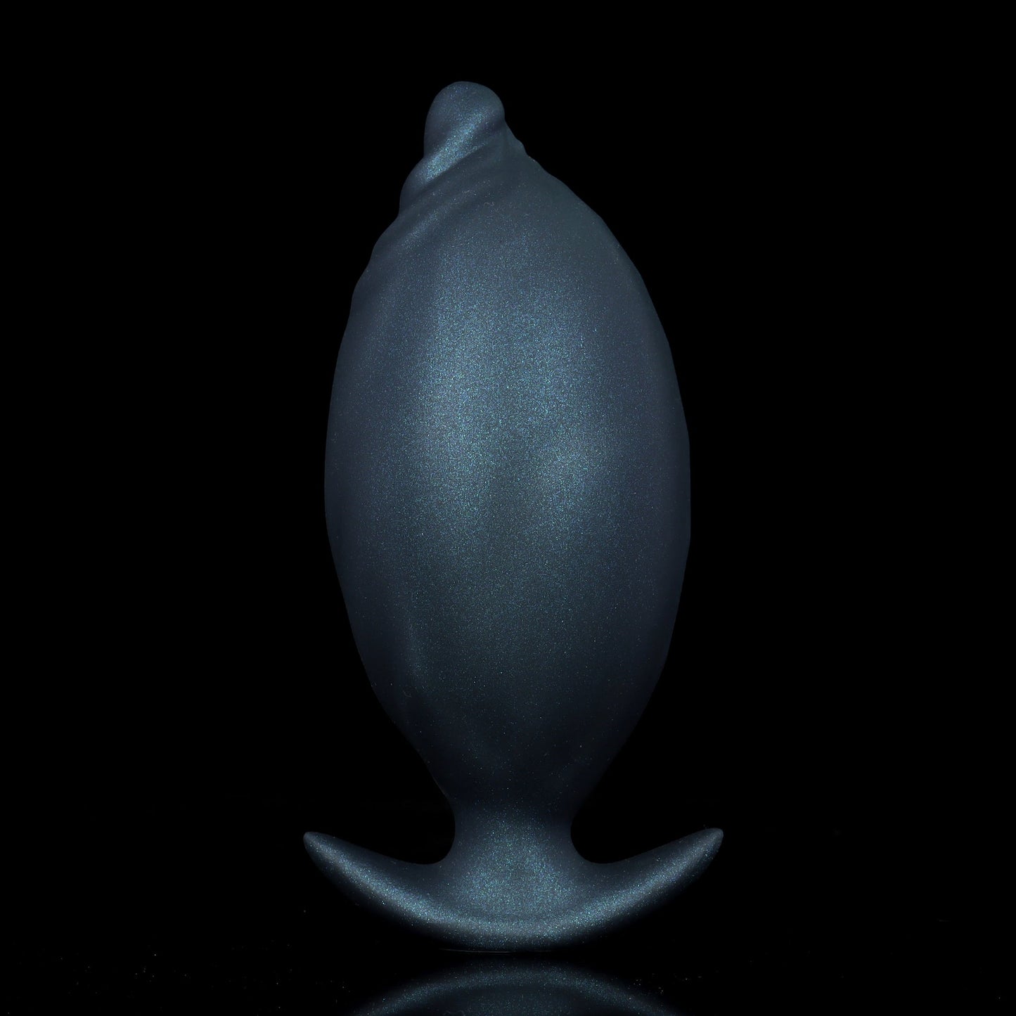 Fully inflated onyx black flexible silicone large anal plug, showing the pristine spherical shape transition for deep pressure.