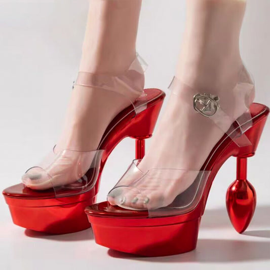 Model wearing 14.5cm metallic red butt plug heels showing transparent buckle ankle strap and thick front platform.