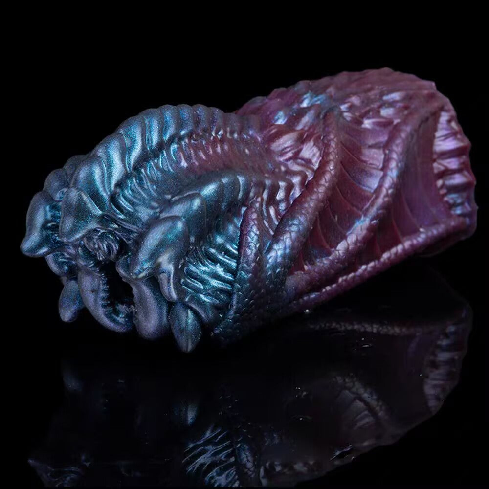 Angled studio shot of a biomorphic alien monster fantasy sex toy, displaying its layered organic textures and ribbed internal chamber entrance.