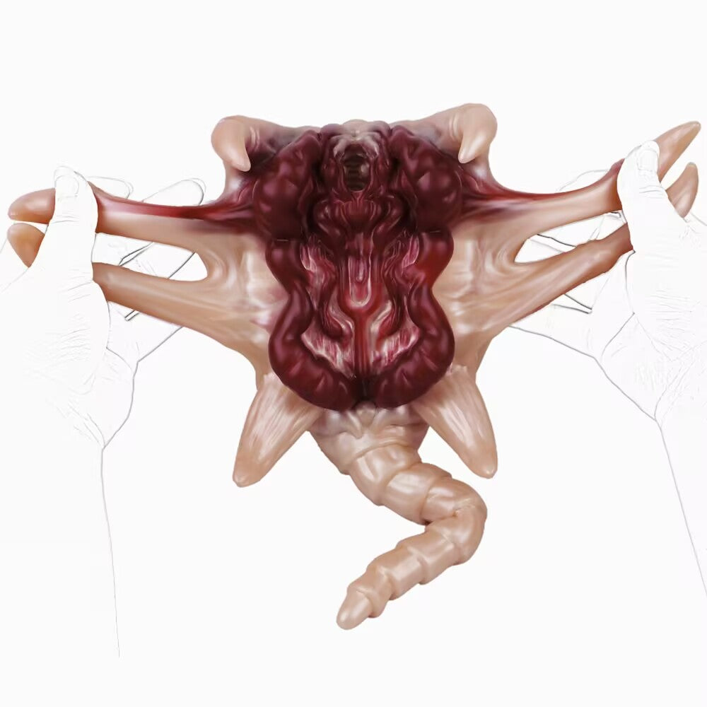 Close-up shot of an Alien Facehugger-themed silicone stroker toy, focusing on the dark red intestinal texture on the inner walls and the surrounding flesh-toned body.