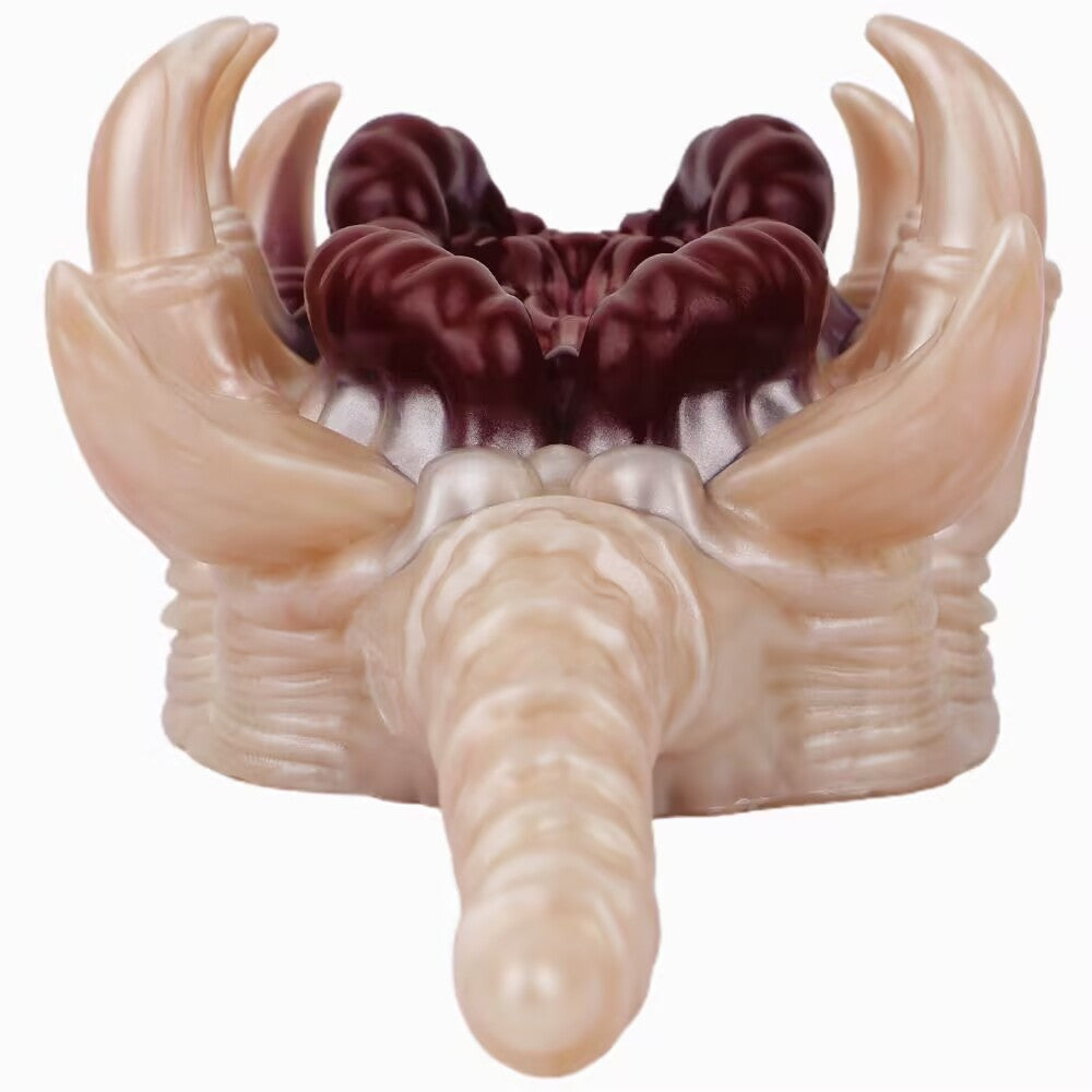 Rear view of alien facehugger silicone stroker focusing on extended tail and inner texture