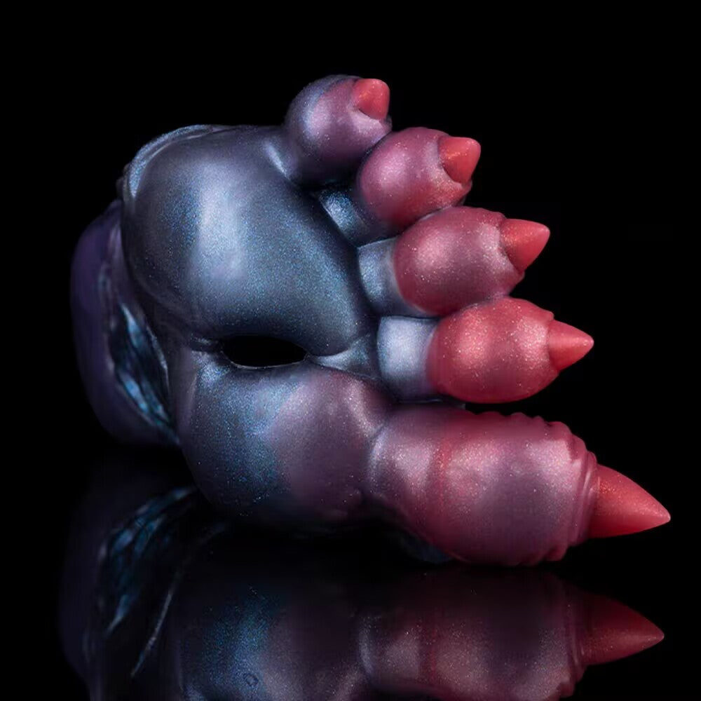 Close-up studio shot of alien foot fetish masturbator with metallic blue and red gradient finish.