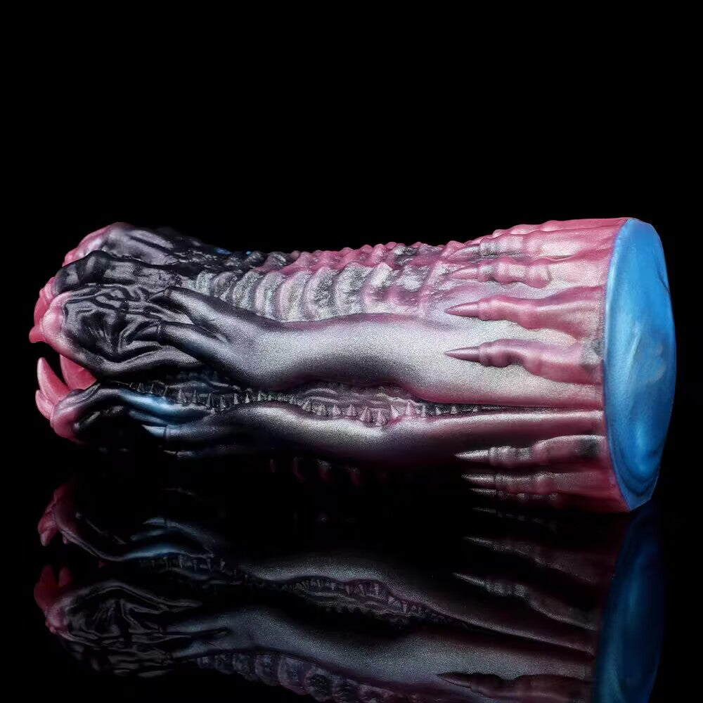 A side view of the alien monster paw male masturbator showing the intricate ribbed exterior contour and heavy textured base designed for premium ergonomic grip.