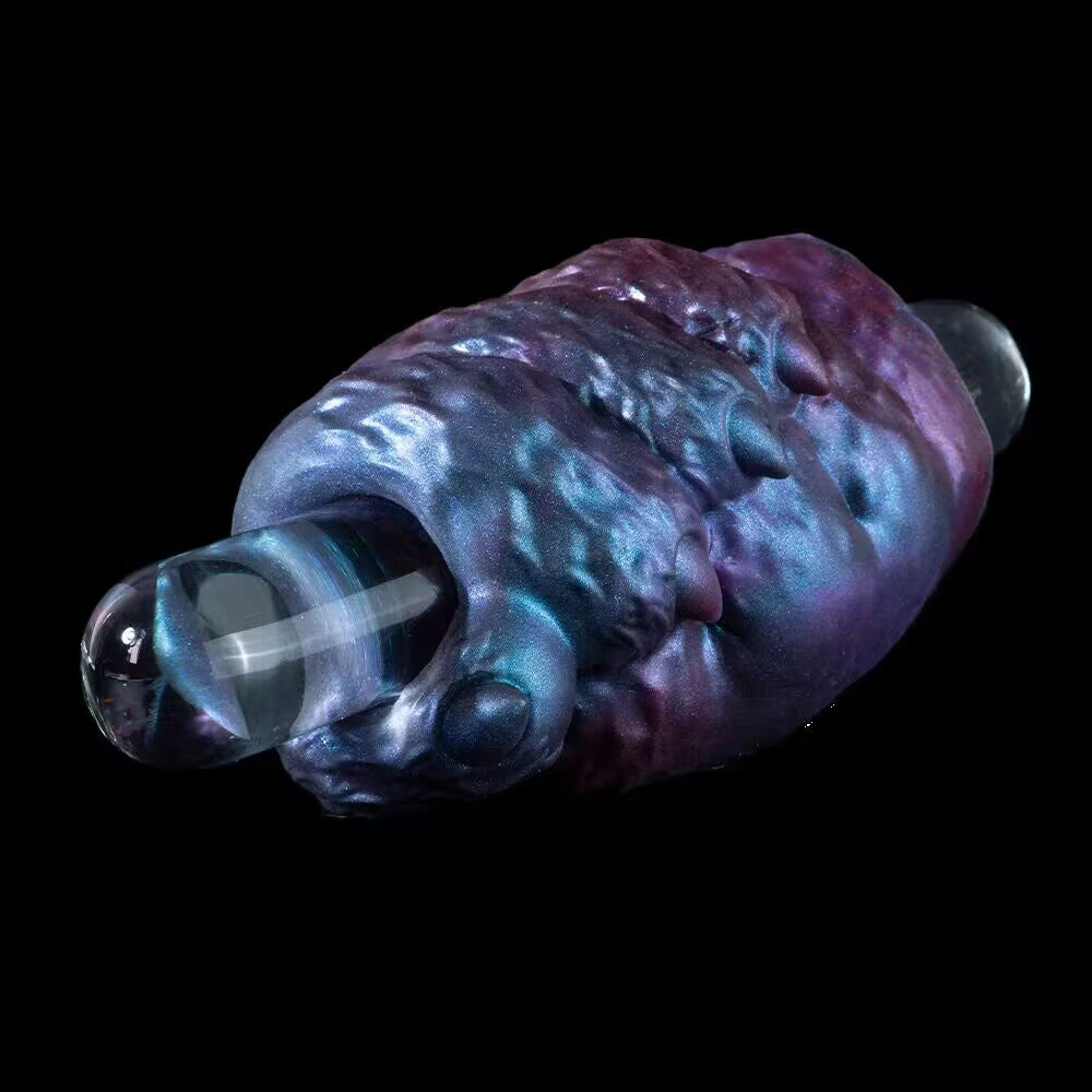 A transparent cylinder passed through a textured purple alien tentacle swirl fantasy stroker, showcasing the open-ended single channel structure.
