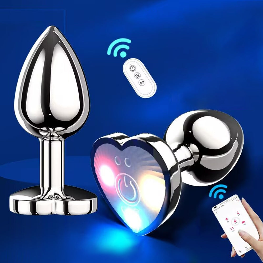 Premium app-controlled metal butt plug with a glowing LED heart base and wireless remote controller on a neon blue background.