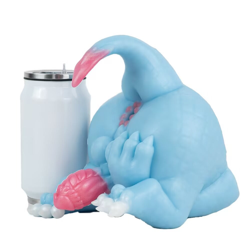 Side view size comparison of the Azure dragon silicone toy sitting next to a standard white beverage tumbler can.