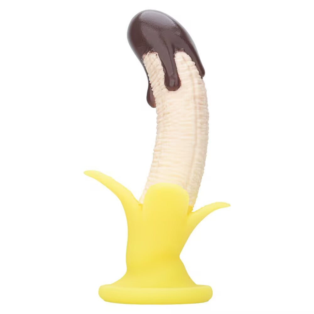 Front view of a chocolate banana silicone dildo standing upright on its suction base.