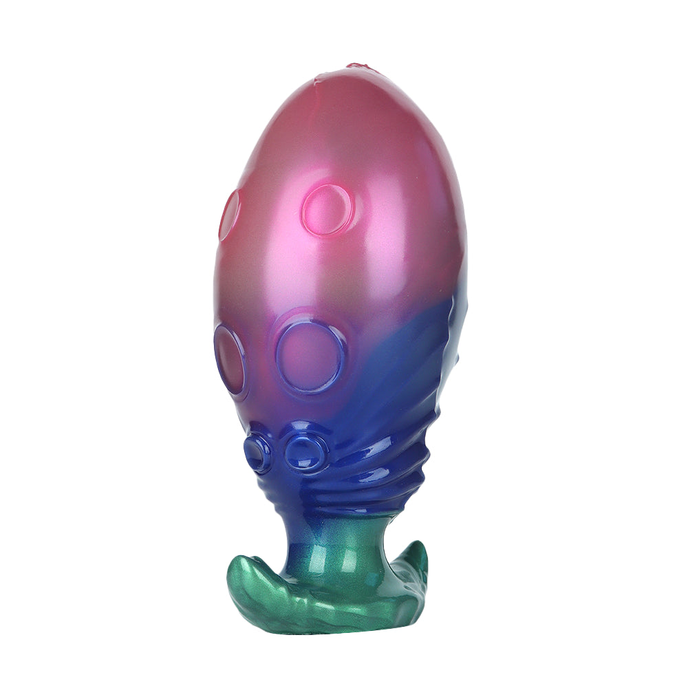 Detailed view of the organic suction cup patterns on a gradient biomorphic alien toy.