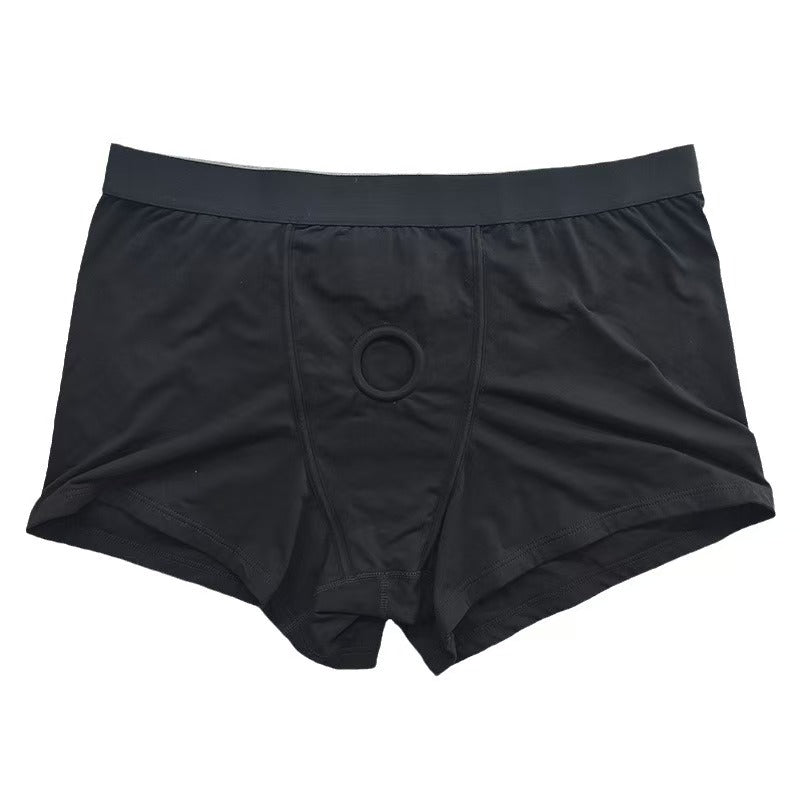 Flat lay of black cotton packing underwear with integrated center pouch and built-in prosthetic harness ring.