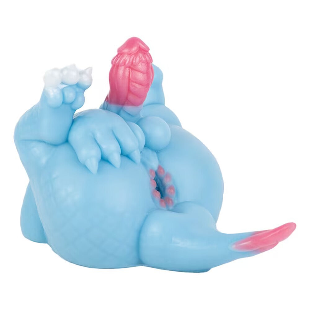 Back view of the Azure dragon toy laying down, showcasing the textured entry point of the internal pleasure pathway below the tail.