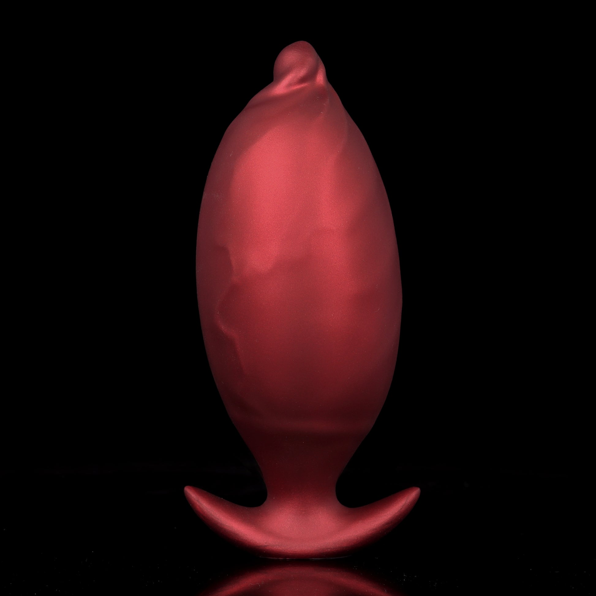 Back view of a premium body-safe silicone inflatable anal plug in crimson red, showcasing its smooth ergonomic curvature and crescent-shaped base.