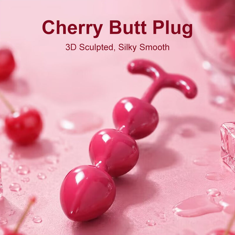 Glossy red cherry butt plug with 3D sculpted beads and ergonomic stem base for smooth anal training.