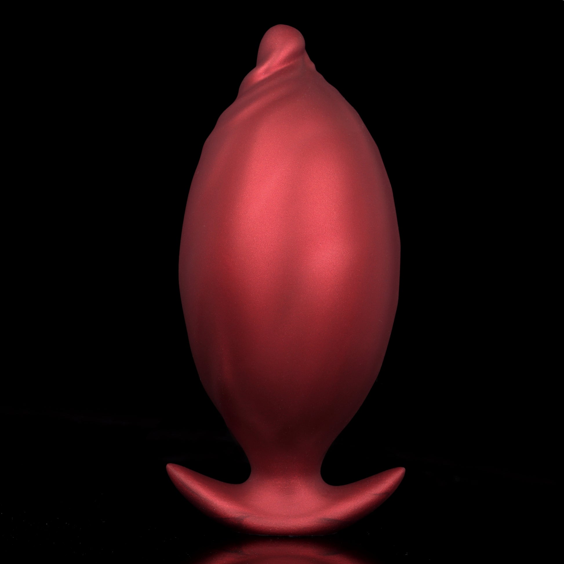 Maximum expanded crimson red inflatable balloon butt plug highlighting the extreme full size transformation and matte texture finish.