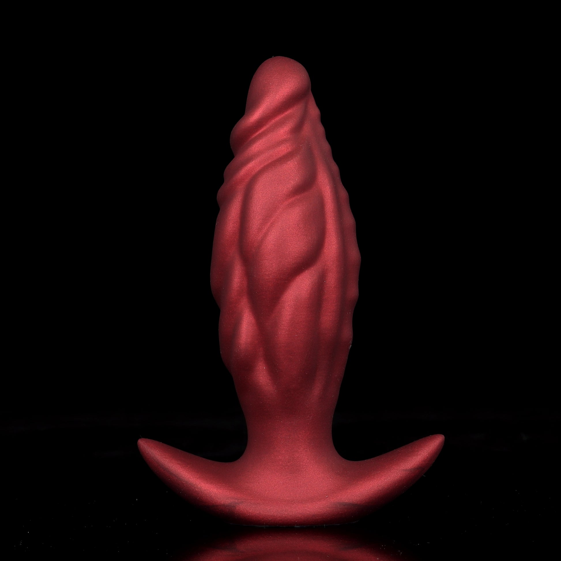 Crimson red textured ripple silicone anal dilator core showcasing the non-slip safety flared wing base on a black background.