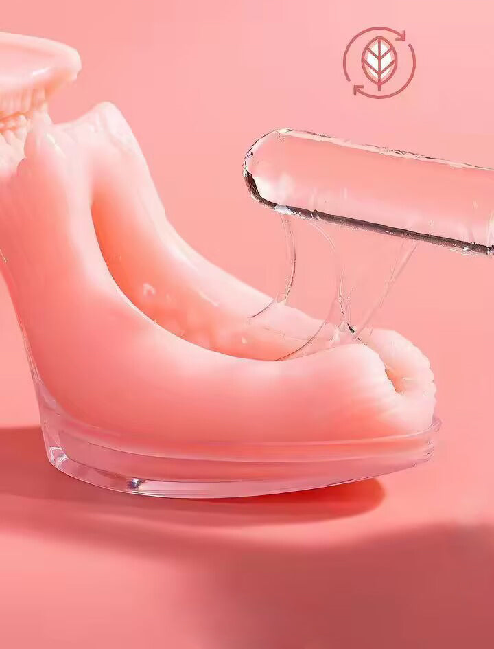 Close-up of a glass rod stretching the highly elastic pink TPE skin of the crystal heel stroker cup, proving eco-friendly material durability.