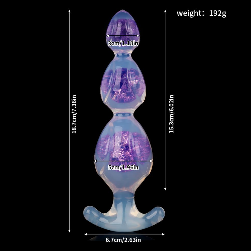 Dimension guide of crystal jelly liquid silicone anal beads in purple showing total height of 18.7cm and flared base of 6.7cm.
