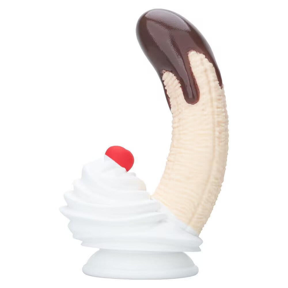 Full side view of the ergonomic curved silicone banana dildo with chocolate top and white suction base.
