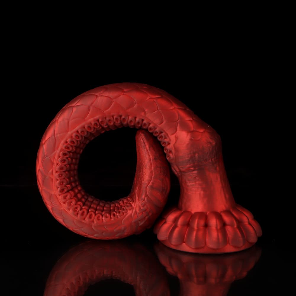 Fully curved crimson dragon tail sex toy showing the exceptional flexibility of the premium liquid silicone material.