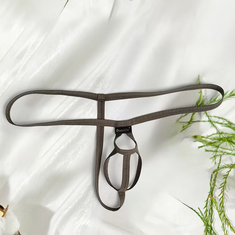 Dark brown men’s minimalist pouch thong underwear with double ring separation on a white textured background.
