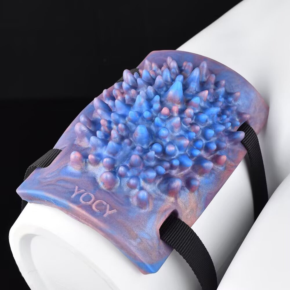 Dense spike textured silicone massager pad with strap slots for thigh or body mounting