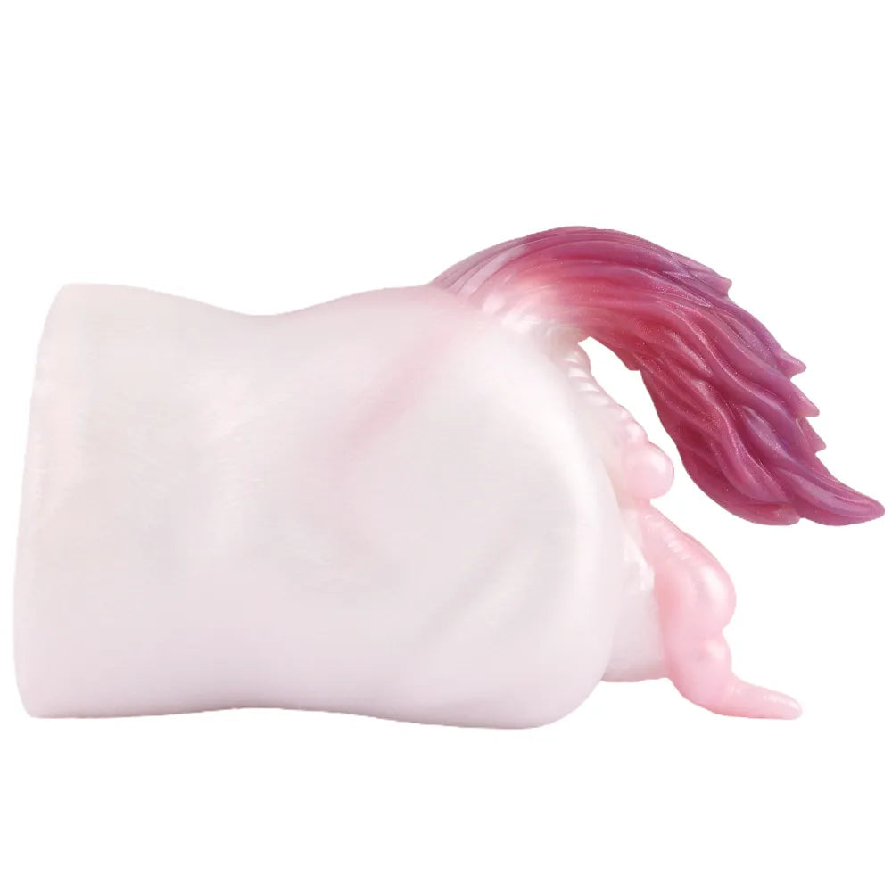 A 22cm long, heavy desktop silicone male stroker with a fantasy creature tail laid horizontally.
