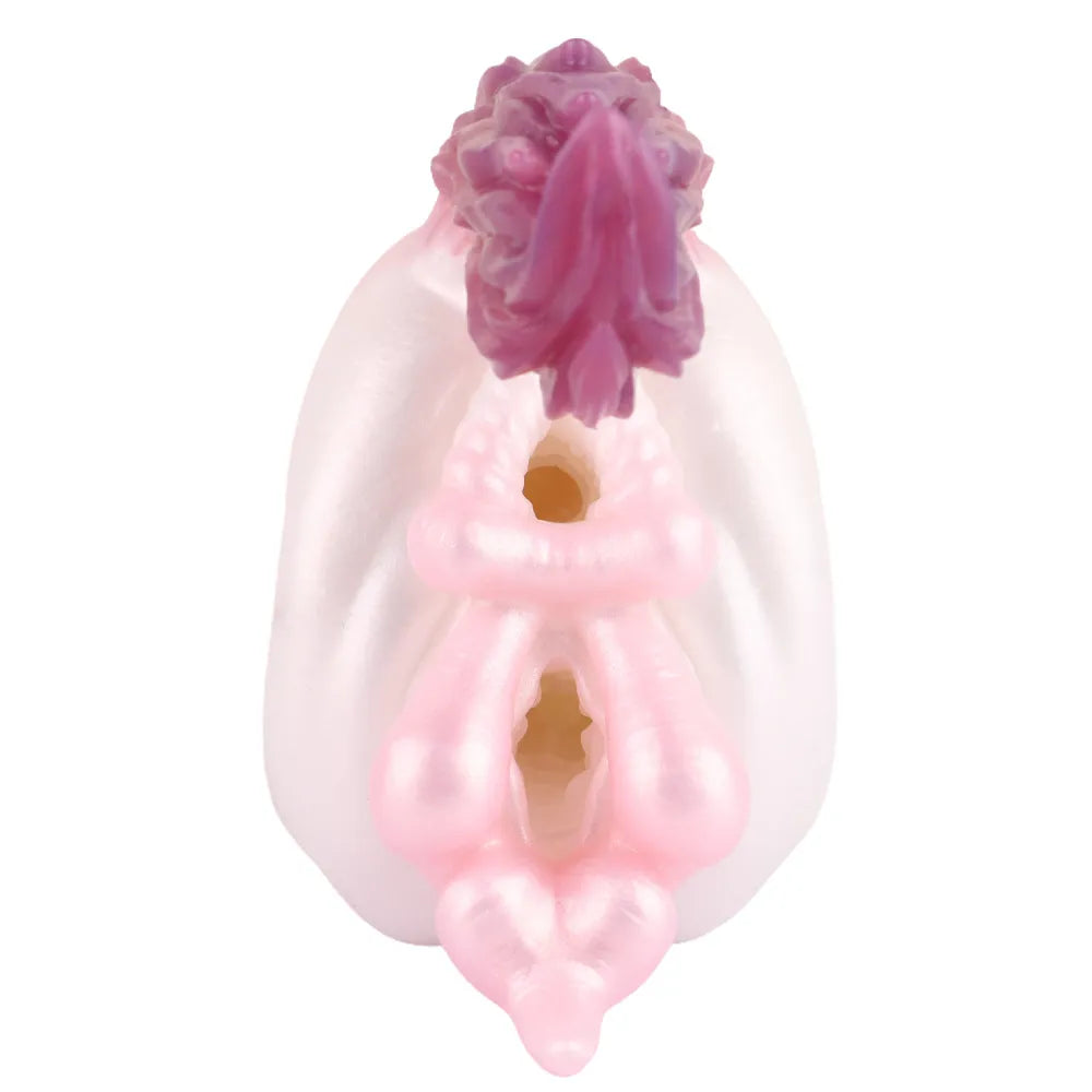 Front view showing the tight dual entry channels of the pink and white fantasy creature silicone male stroker.
