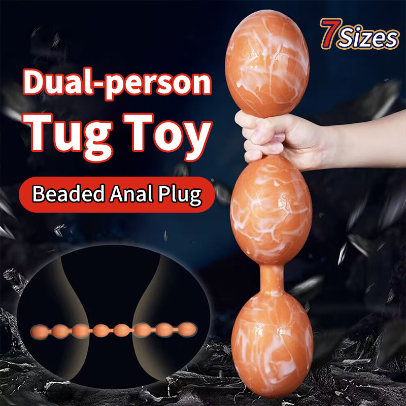 Dual person tug toy flexible marble orange beaded anal plug holding three large beads.