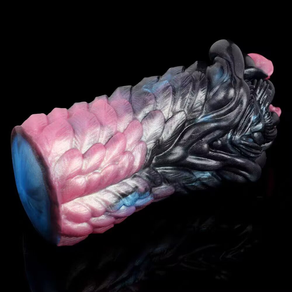 An angled studio shot of the Eldritch Beast Claw fantasy male masturbator, highlighting the realistic overlapping monster scales and premium pink-to-black gradient body-safe silicone.