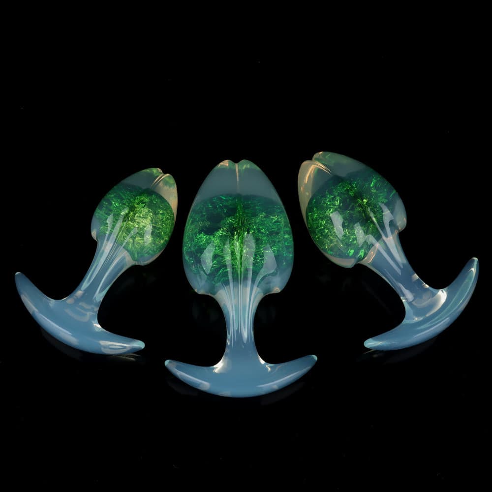 Three emerald-green forest themed crackle-effect plugs, displaying the flared security T-bar base and seamless, sleek contours.