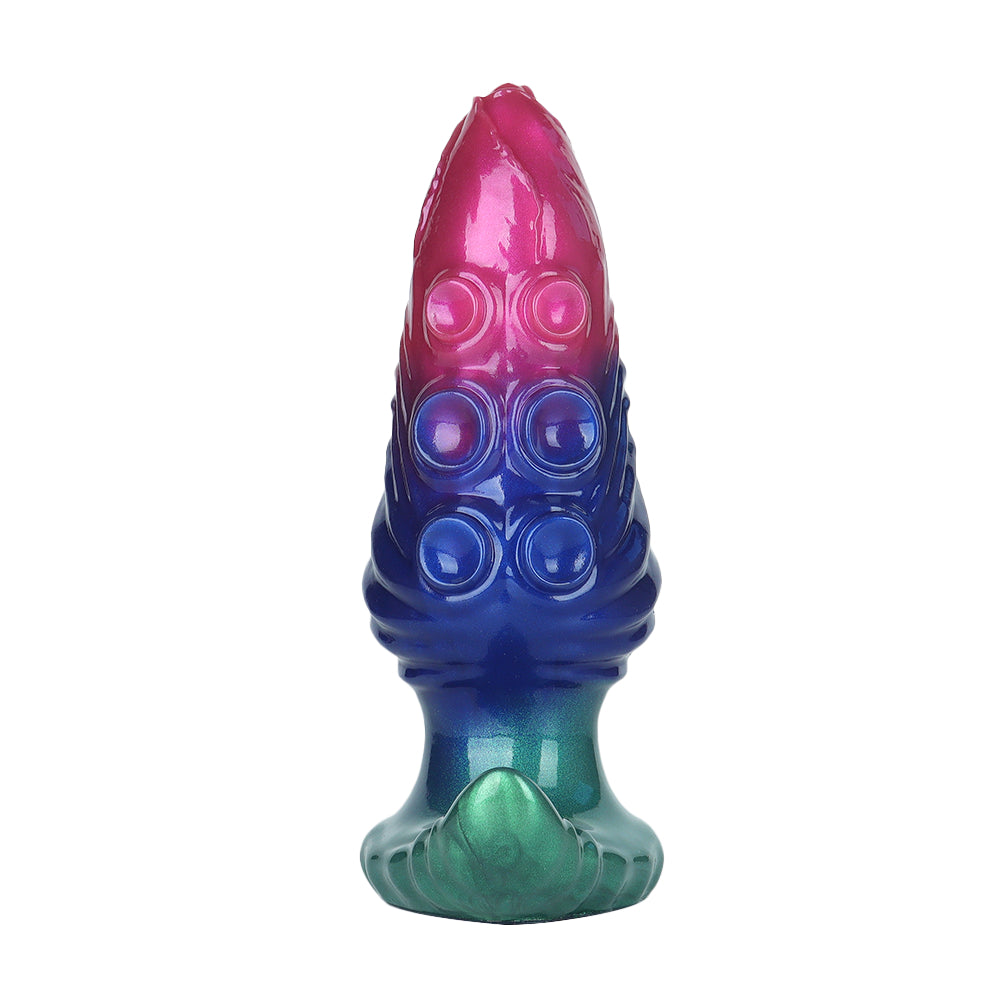 Close-up of an expandable alien butt plug featuring prominent bioluminescent-style suction cups and ridged body texture