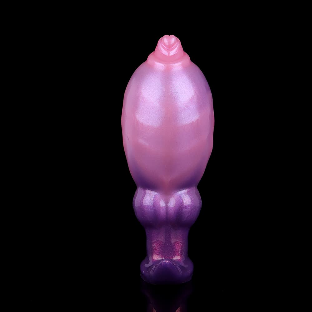 Fully expanded anal dilator toy with a smooth metallic pearlescent pink sheen, resting on a reflective black surface.