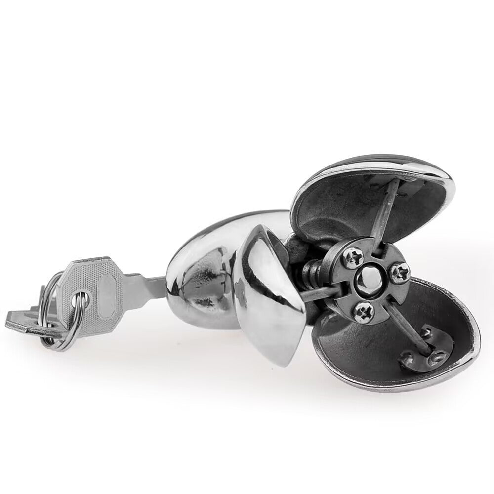 Bottom view of expanded metal blossom plug showing four-blade mechanism with key inserted.