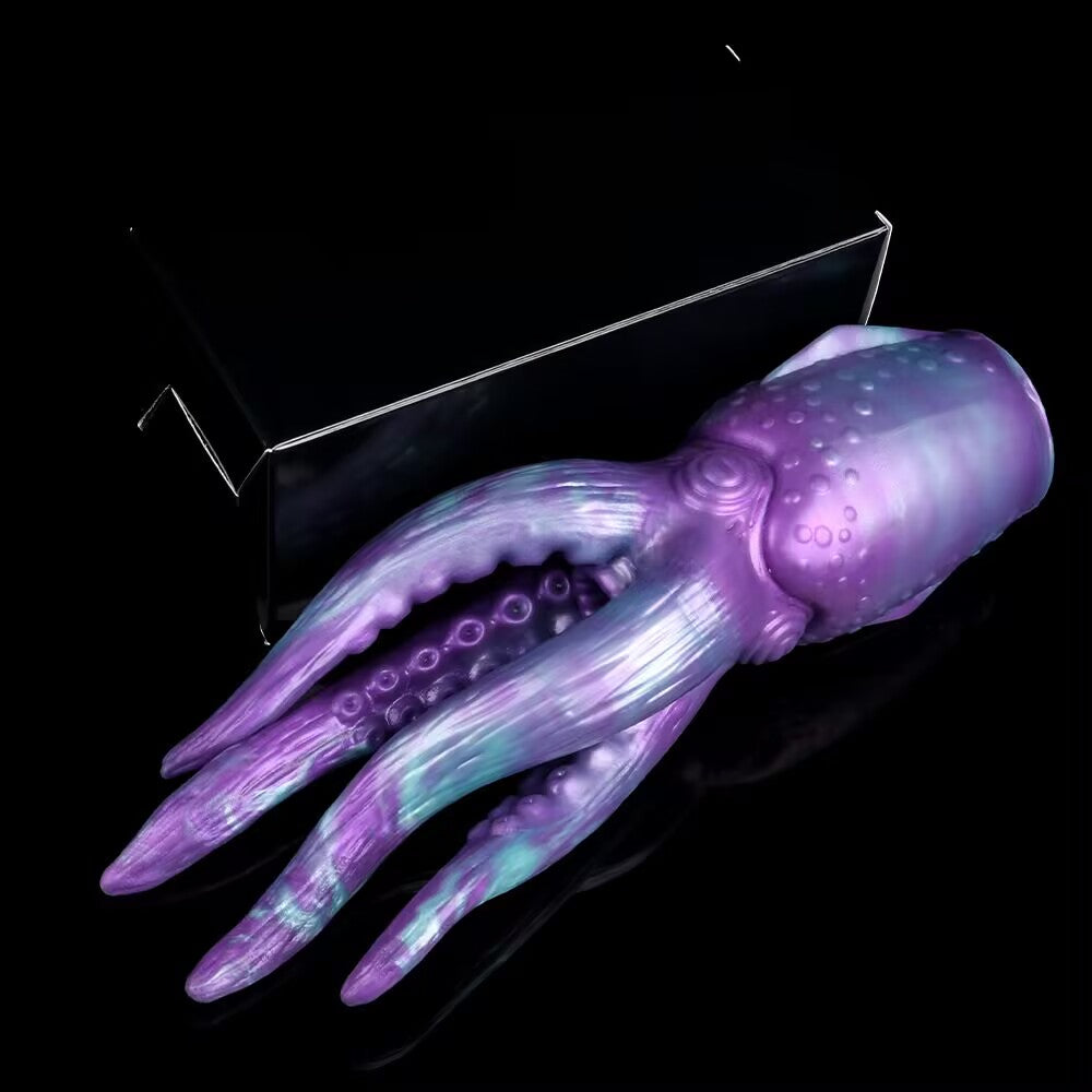Fantasy monster tentacle male pleasure stroker lying next to packaging box