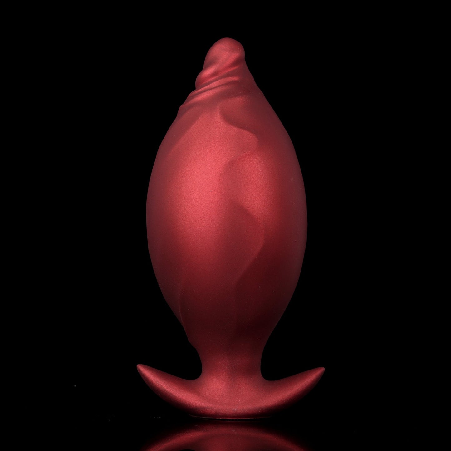 Side-by-side comparison of a crimson red inflatable fantasy dilator before and after being pumped into a large egg shape.