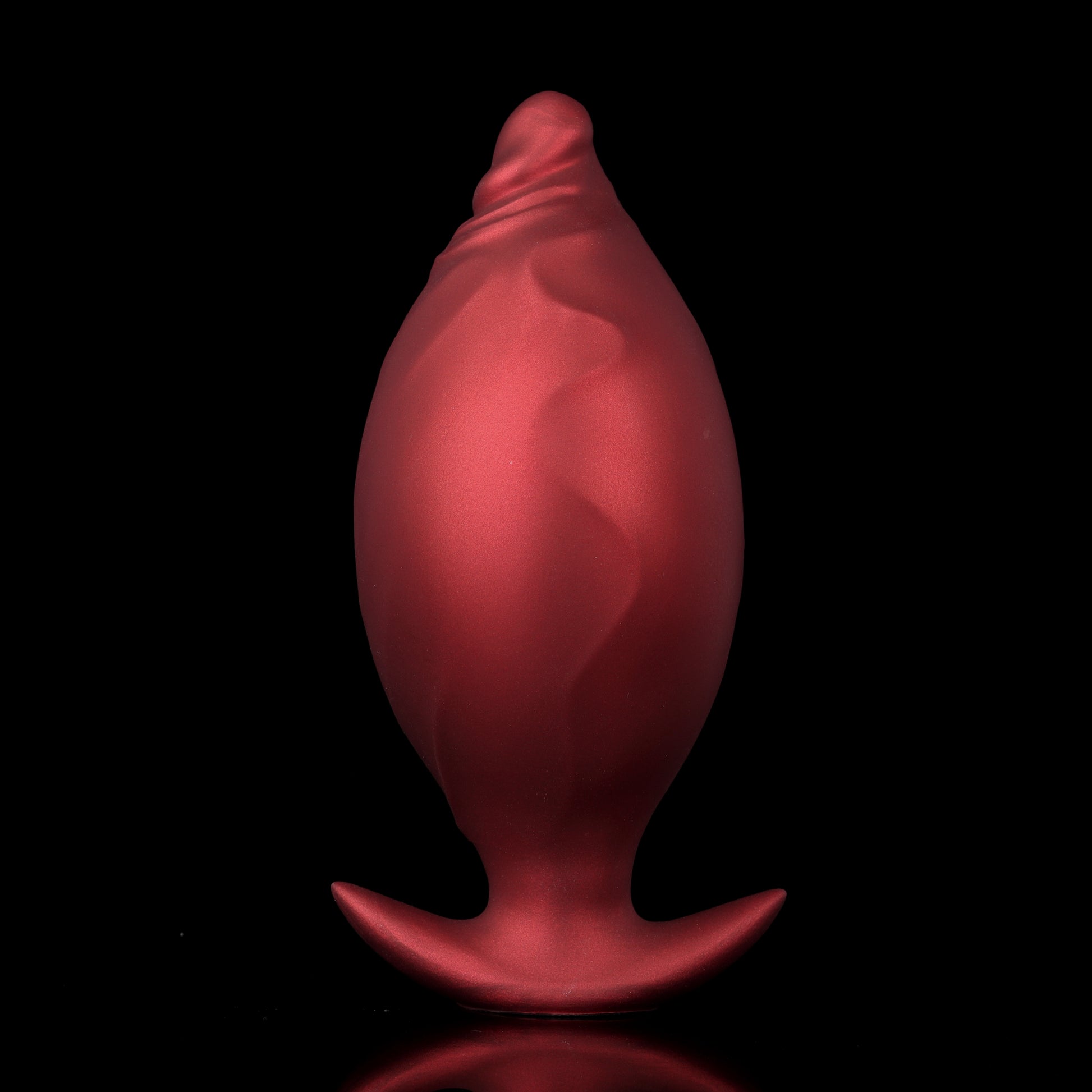 Side-by-side comparison of a crimson red inflatable fantasy dilator before and after being pumped into a large egg shape.