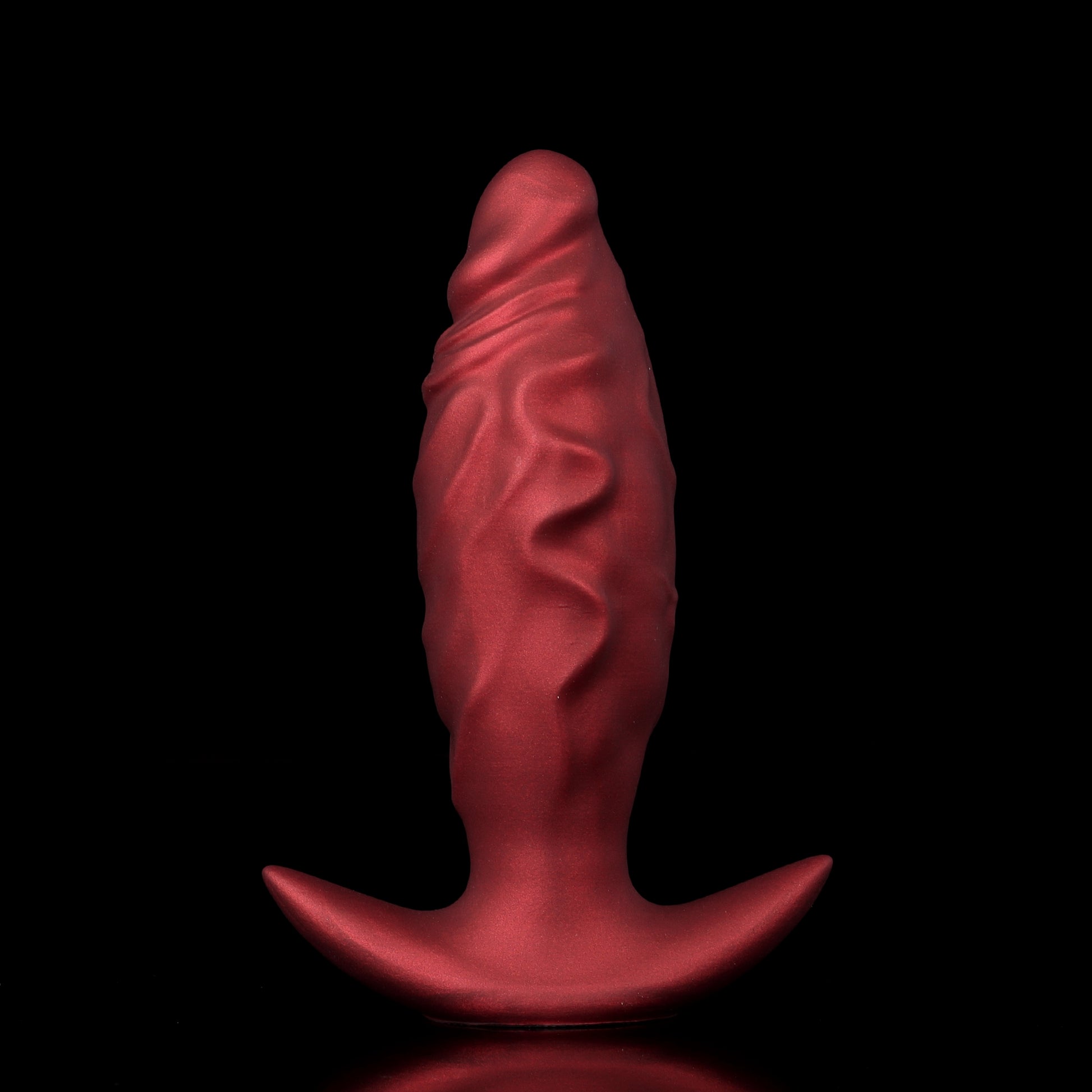 Side-by-side comparison of a crimson red inflatable fantasy dilator before and after being pumped into a large egg shape.