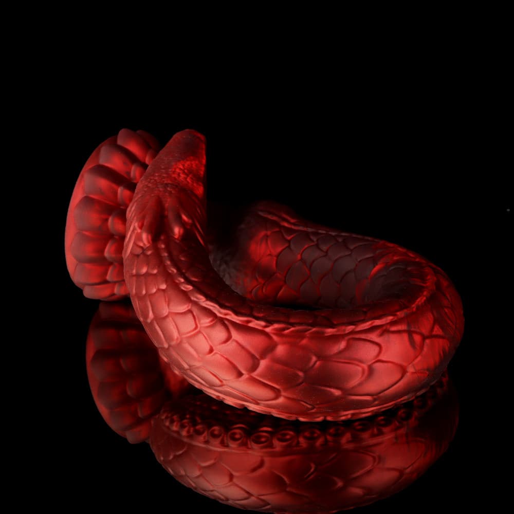Coiled red silicone dildo highlighting the row of intricate octopus suction cups for internal stimulation.