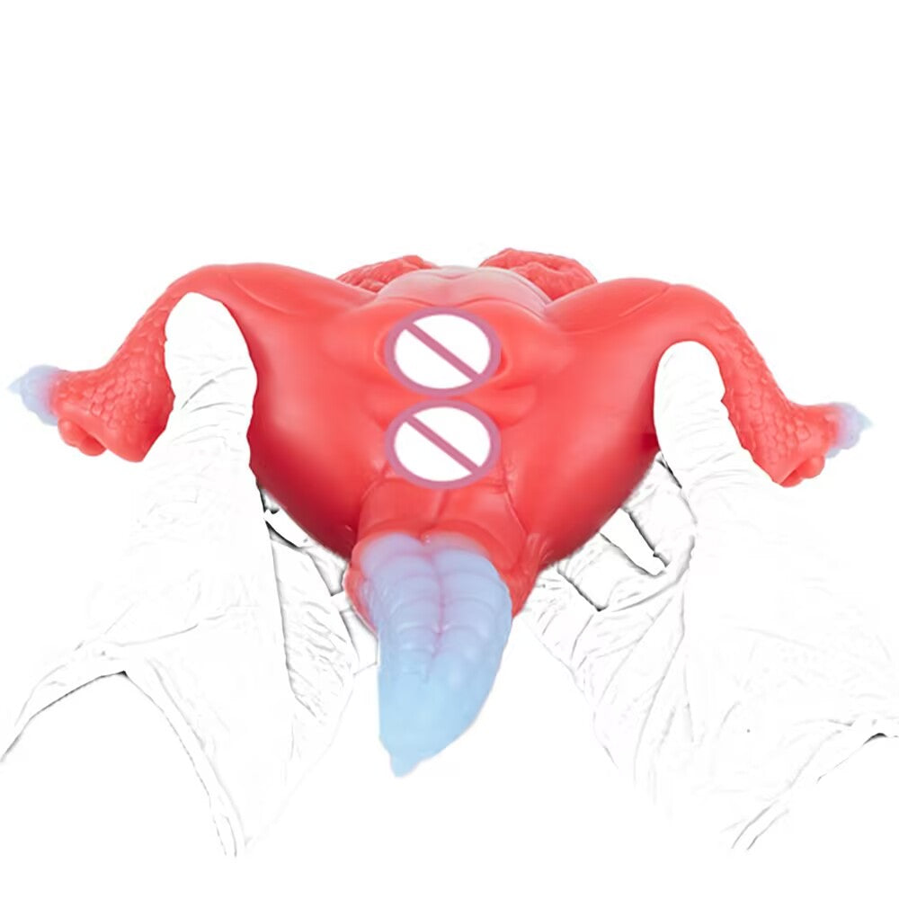 A view from behind the Crimson dragon silicone toy being held by gloved hands, showing its thick curves and flexible body texture.