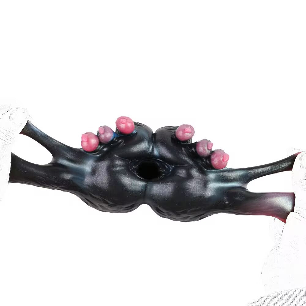 Extreme horizontal stretching test showing flexibility of TPE dragon masturbator.
