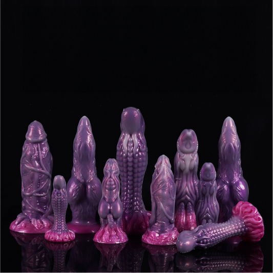 The complete Violet Abyss collection of fantasy toys displayed on a sleek black surface.