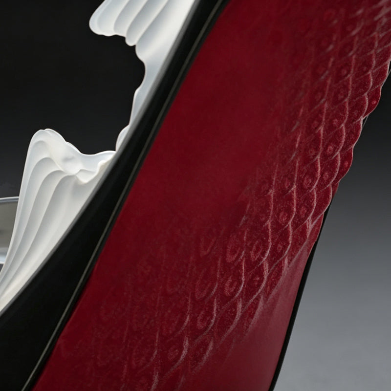 Detailed view of the iconic red sole with anti-slip patterned texture on high heel shaped male stroker.
