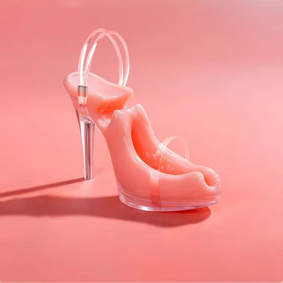 Standalone product shot of the high heel masturbator toy featuring pink soft TPE texture inside a clear high heel sandal.