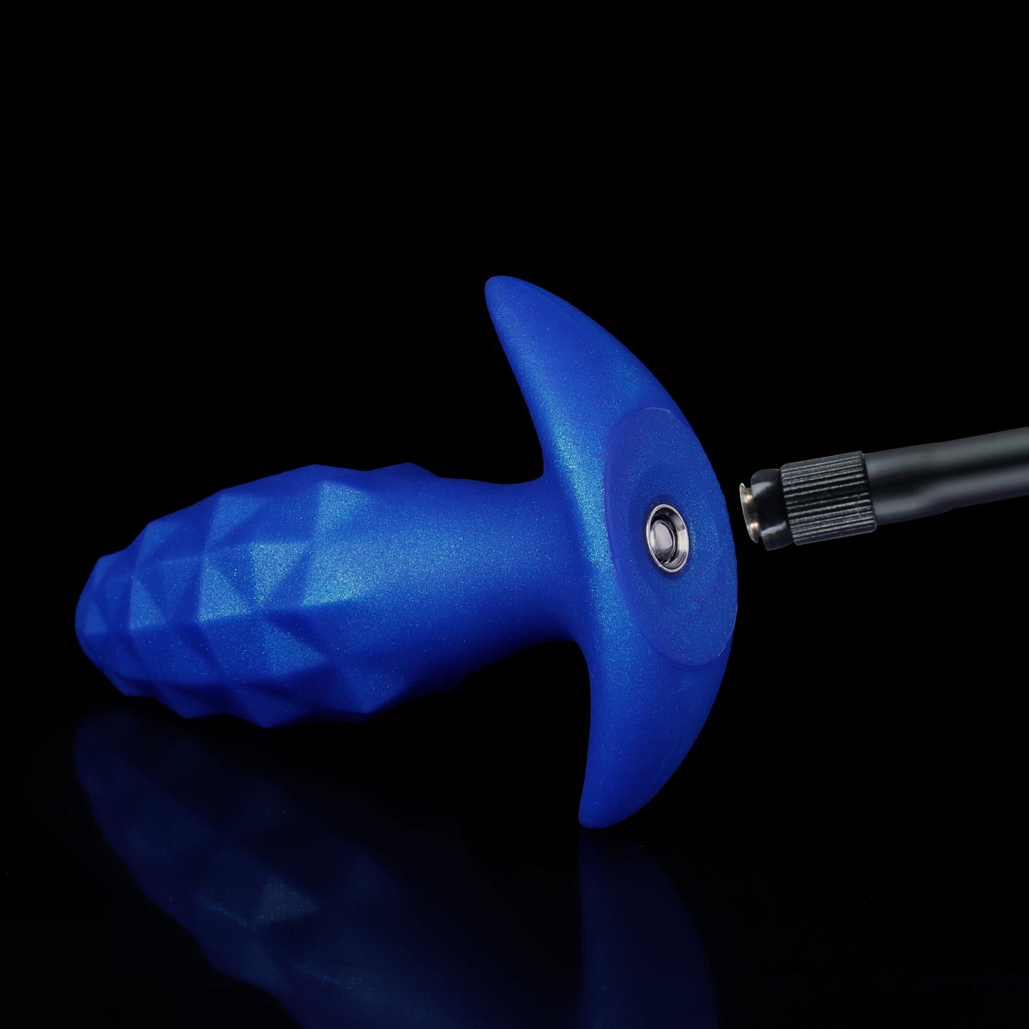 Close-up of a blue diamond-faceted inflatable silicone plug showing the premium medical-grade metal air valve ready to connect to a black air pump hose.
