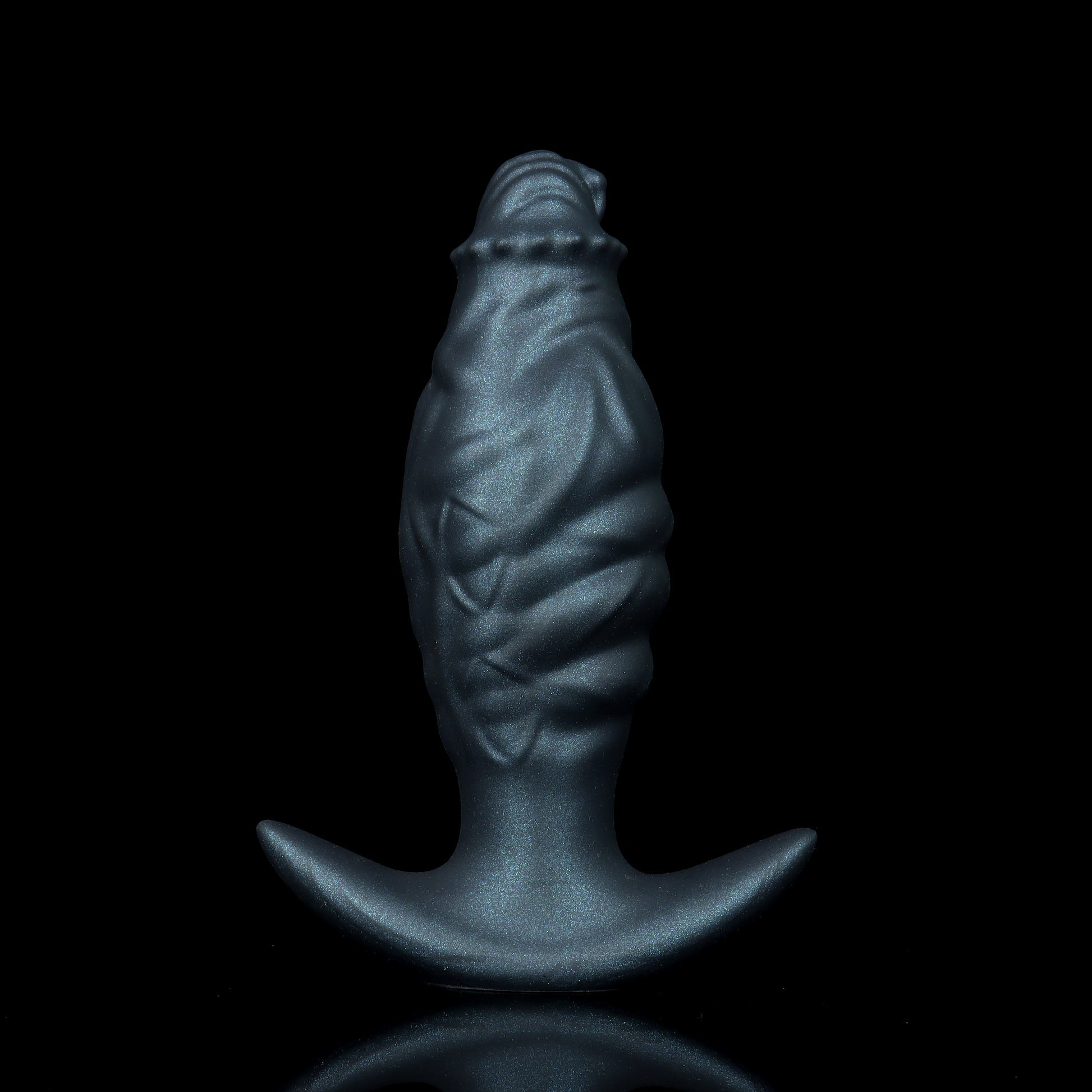 A hand wearing a white glove holds a metallic blue, textured inflatable fantasy butt plug against a black background.