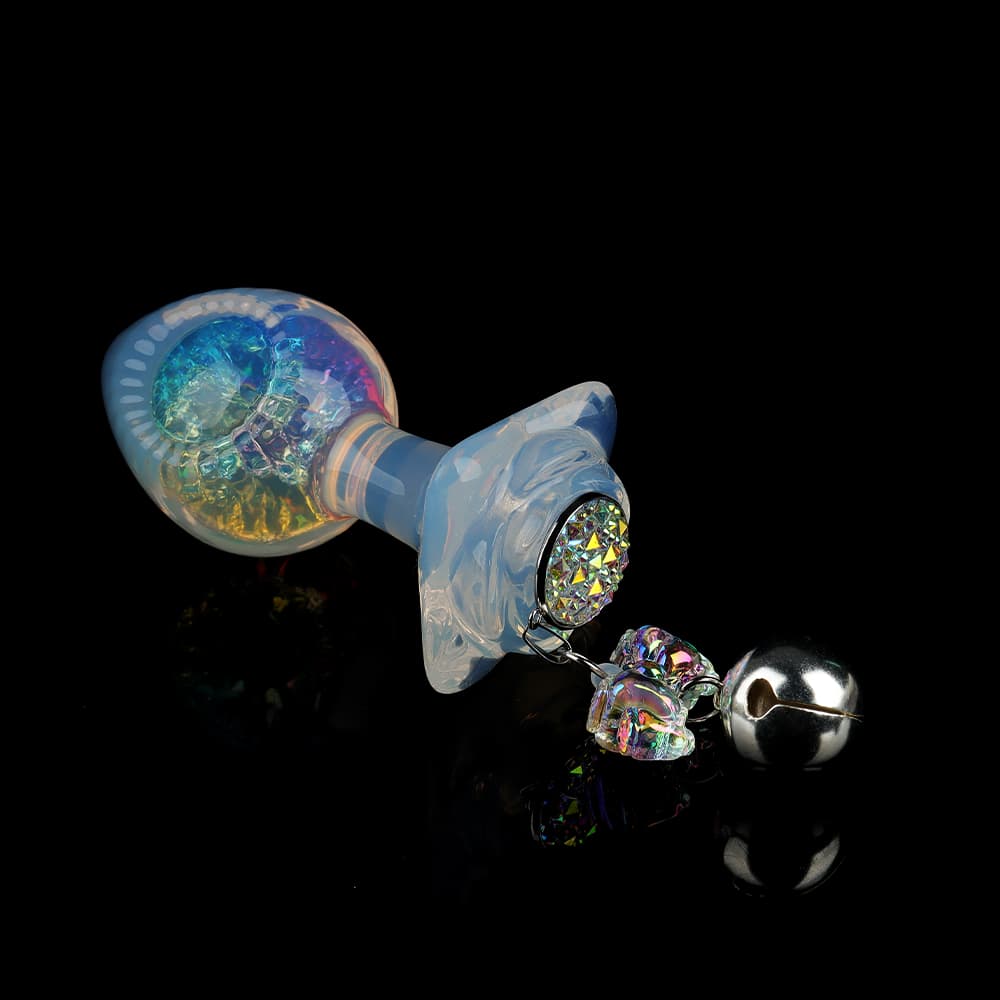 Luxury iridescent glass butt plug with a rainbow crystal center and a playful jingle bell attachment.