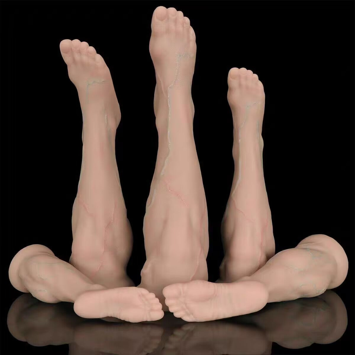 Multi-size collection of lifelike foot silicone anal plugs with realistic veins and wide suction bases.