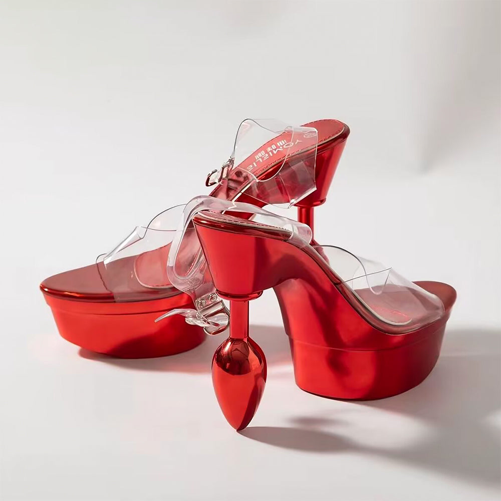 Pair of metallic red platform heel sandals featuring a unique butt plug shaped high heel design with clear PVC straps.