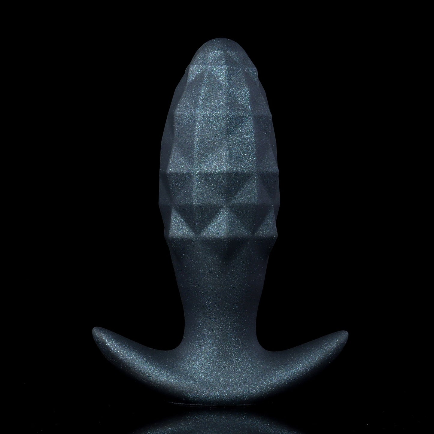 A midnight black inflatable silicone butt plug with a subtle glitter shimmer and textured diamond facets, standing upright against a black backdrop.