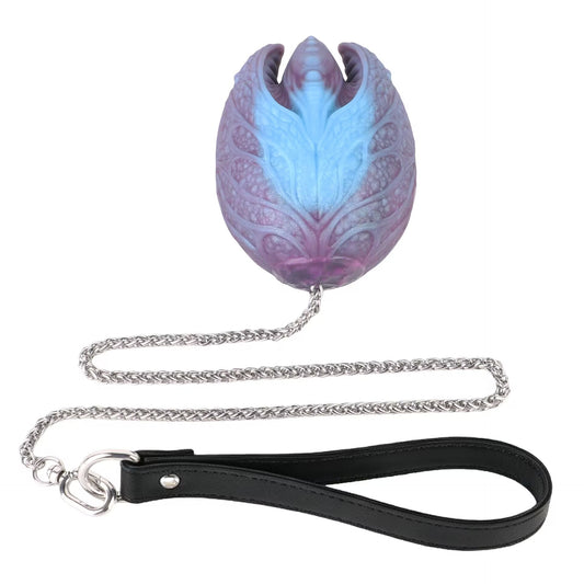 Single mystic egg silicone body bead attached to chain and leather loop on white background.